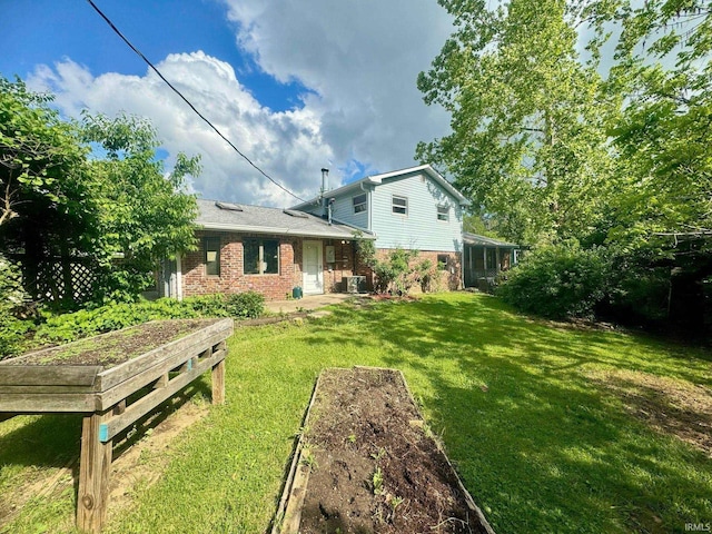 rear view of house with a yard