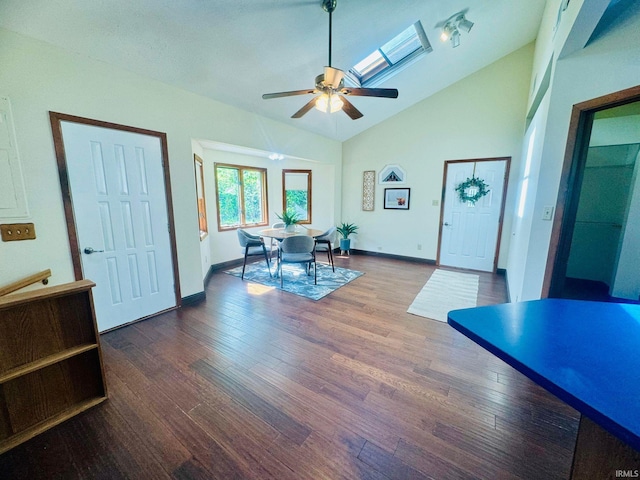 interior space featuring a skylight, hardwood / wood-style flooring, high vaulted ceiling, and ceiling fan