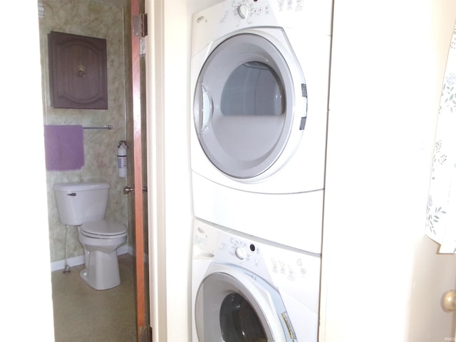 laundry area featuring stacked washer / drying machine