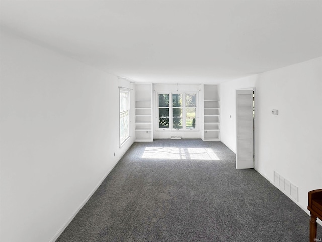 empty room with carpet and built in features