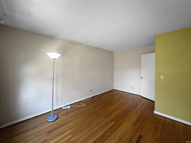 empty room featuring dark hardwood / wood-style flooring