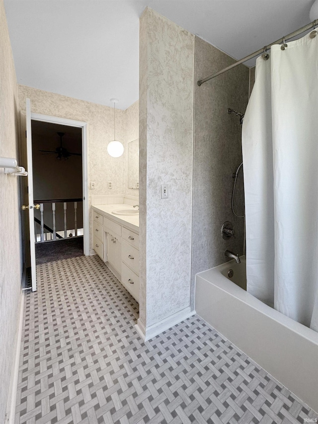 bathroom featuring parquet flooring, shower / bath combination with curtain, and vanity