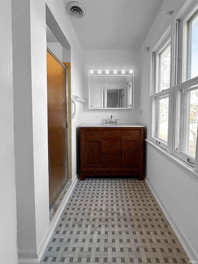 bathroom featuring vanity, parquet floors, and walk in shower