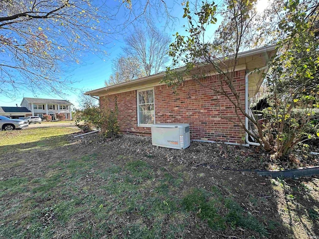 view of side of home featuring a lawn