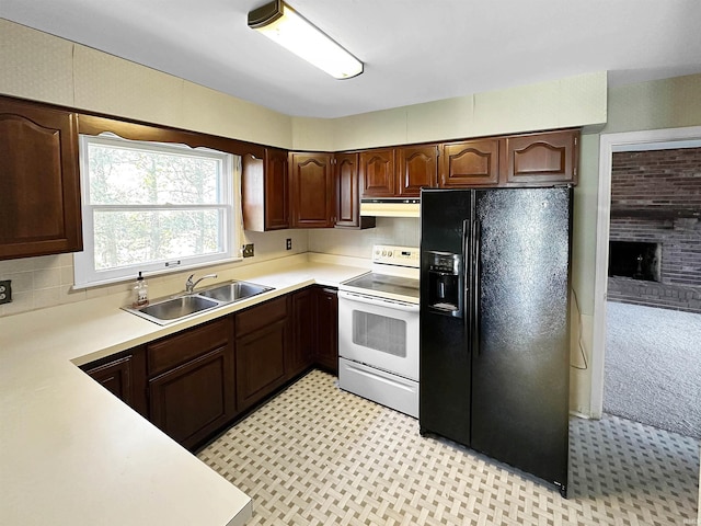 kitchen featuring a brick fireplace, black fridge with ice dispenser, dark brown cabinetry, white range with electric stovetop, and sink