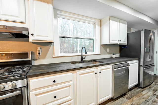 kitchen with sink, white cabinets, and stainless steel appliances