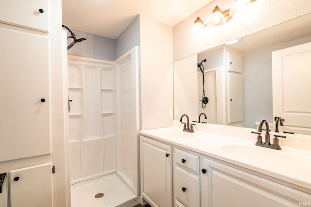 bathroom featuring a shower and vanity