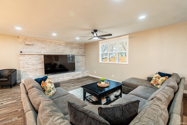 living room featuring hardwood / wood-style floors and ceiling fan