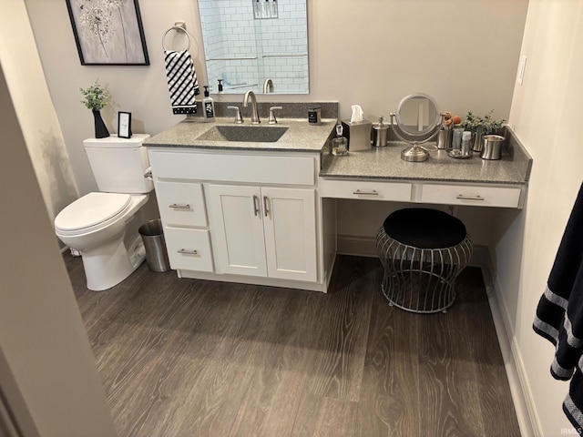 bathroom with hardwood / wood-style flooring, vanity, toilet, and walk in shower