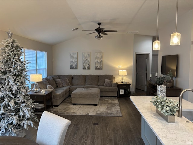 living room with dark hardwood / wood-style floors, ceiling fan, and lofted ceiling