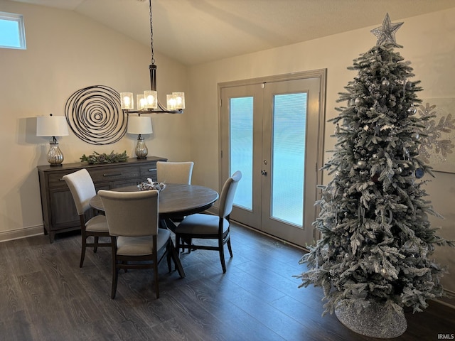 dining room featuring dark hardwood / wood-style floors, lofted ceiling, french doors, and a chandelier