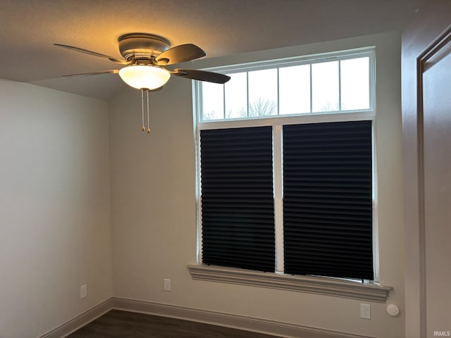 spare room with ceiling fan and dark hardwood / wood-style floors