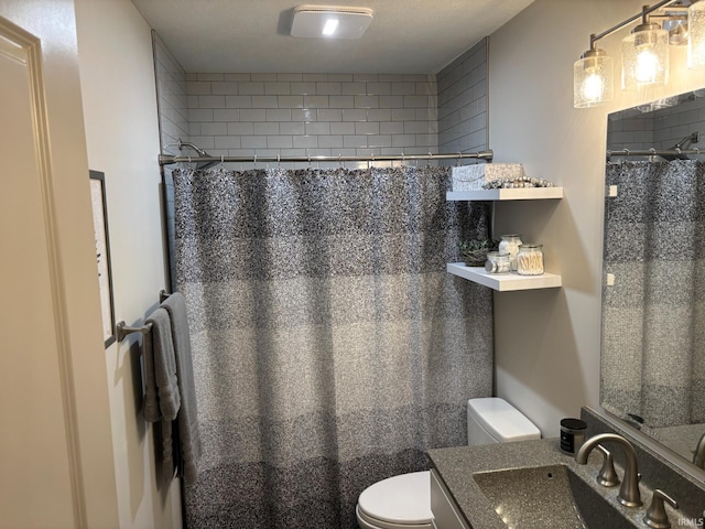 bathroom with a shower with curtain, vanity, a textured ceiling, and toilet