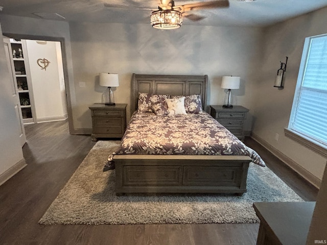 bedroom with ceiling fan and dark wood-type flooring