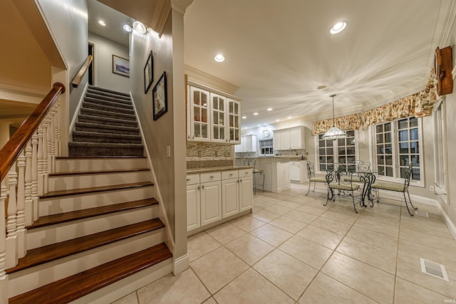 stairs with tile patterned flooring and a chandelier