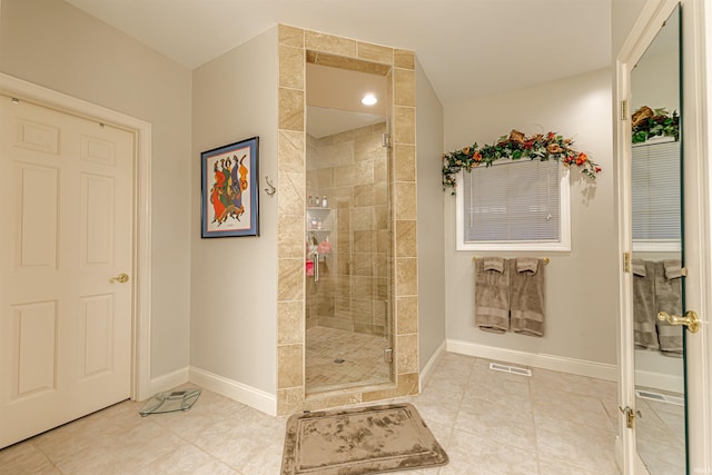 bathroom featuring tile patterned floors and a shower with door