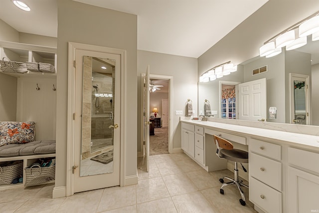 bathroom featuring tile patterned flooring, vanity, ceiling fan, and an enclosed shower