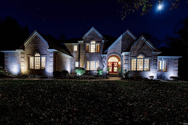 view of front of property with a lawn and french doors