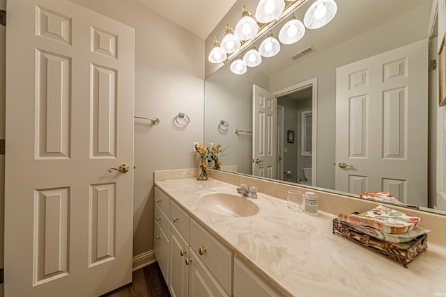 bathroom featuring vanity, toilet, and wood-type flooring