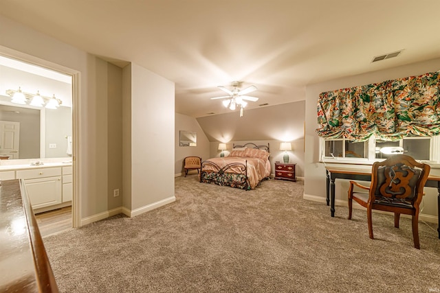 carpeted bedroom with ensuite bathroom and ceiling fan