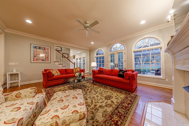 living room with french doors, light hardwood / wood-style flooring, ceiling fan, and crown molding