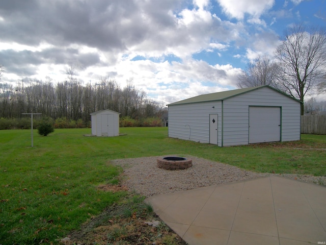 view of yard featuring a shed and a fire pit