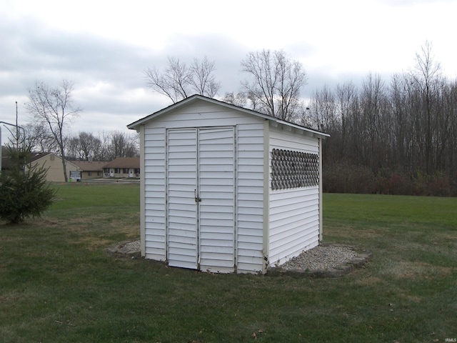 view of outbuilding with a yard