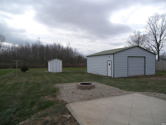 exterior space featuring a storage shed, an outdoor fire pit, and a patio