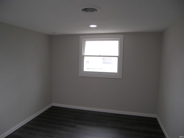 spare room featuring dark wood-type flooring