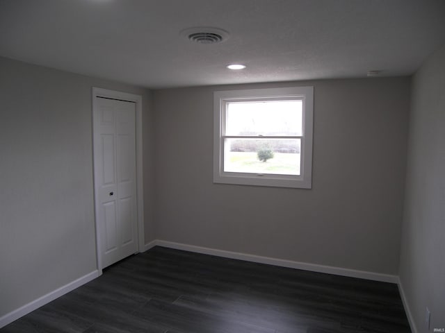 unfurnished room featuring dark hardwood / wood-style flooring