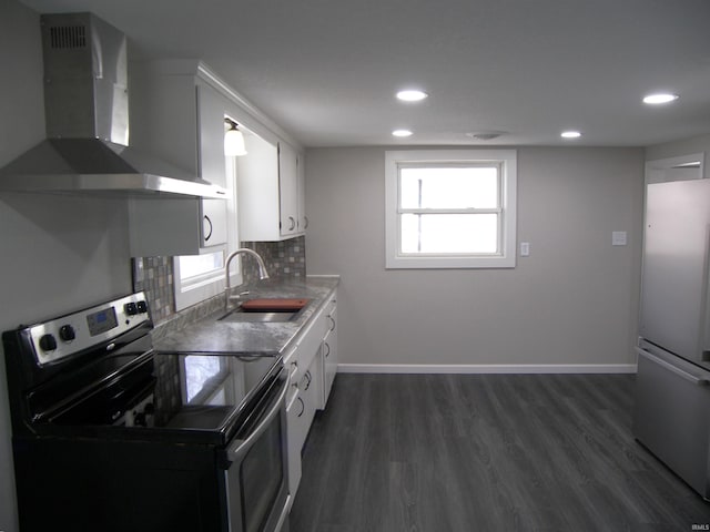 kitchen featuring white cabinetry, sink, stainless steel appliances, wall chimney range hood, and dark hardwood / wood-style floors