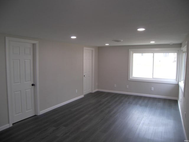 empty room featuring dark hardwood / wood-style flooring