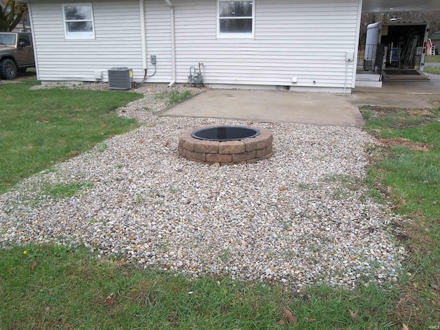 view of patio / terrace with central AC and an outdoor fire pit