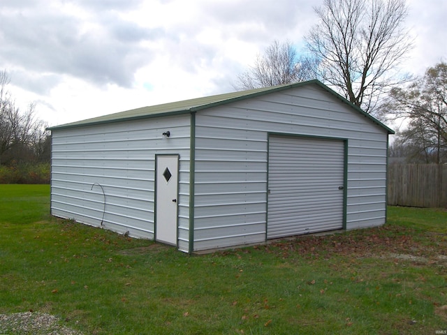 view of outbuilding with a garage and a yard