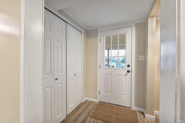 entryway with crown molding and hardwood / wood-style floors