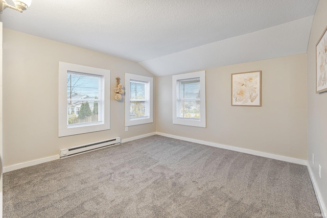 unfurnished room featuring a textured ceiling, lofted ceiling, carpet floors, and a baseboard heating unit