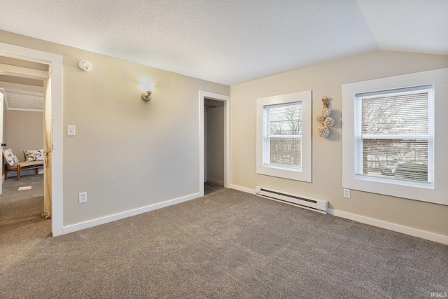 spare room featuring a wealth of natural light, carpet, a baseboard radiator, and lofted ceiling