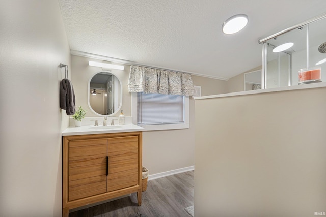 bathroom featuring vanity, a textured ceiling, and hardwood / wood-style flooring