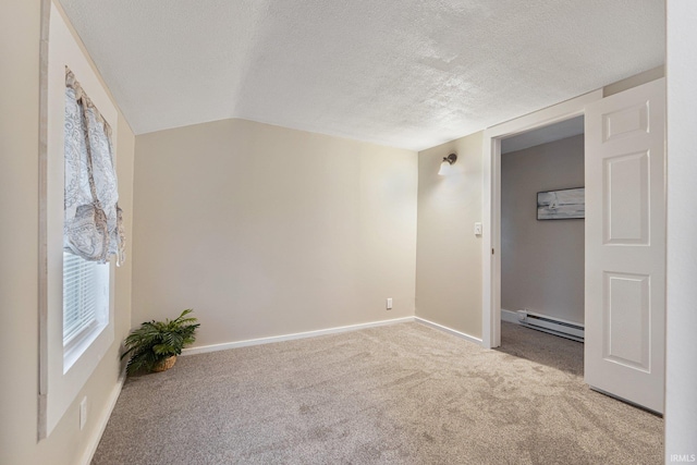 empty room featuring a textured ceiling, lofted ceiling, light carpet, and a baseboard heating unit