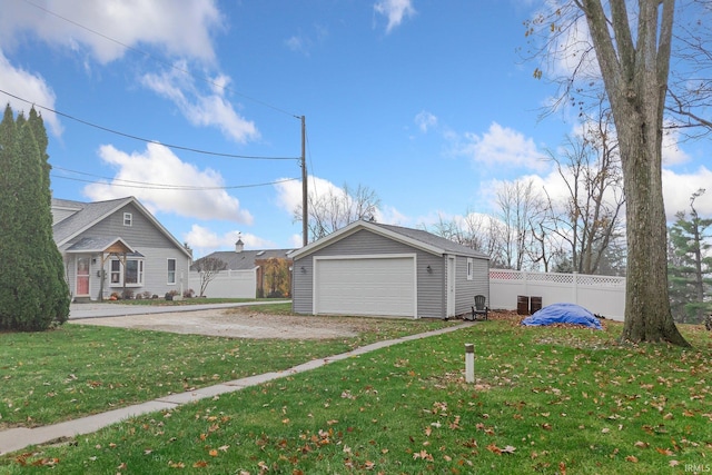 exterior space with a yard, a garage, and an outdoor structure