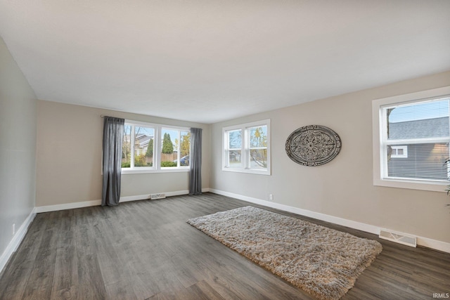 spare room with dark wood-type flooring