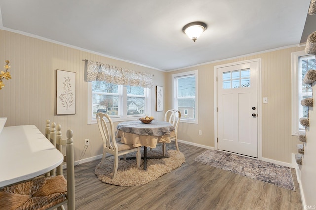 dining room featuring crown molding, hardwood / wood-style floors, and plenty of natural light