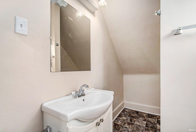 bathroom with vanity and vaulted ceiling