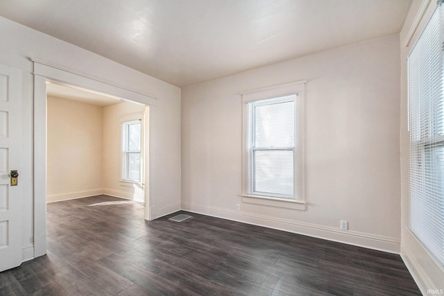 spare room featuring dark hardwood / wood-style flooring