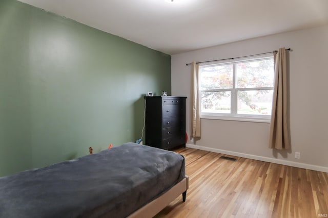 bedroom with light hardwood / wood-style floors