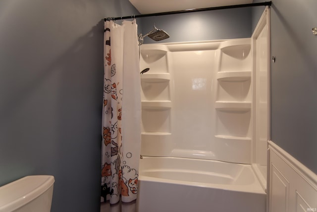 bathroom featuring shower / bathtub combination with curtain and toilet