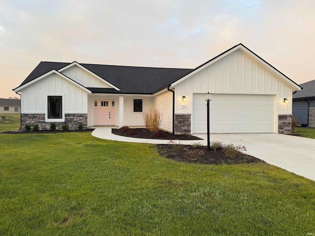 view of front of home featuring a garage and a lawn