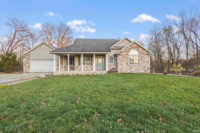 view of front facade featuring covered porch, a garage, and a front yard