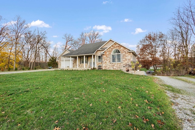 view of property featuring a porch, a garage, and a front yard