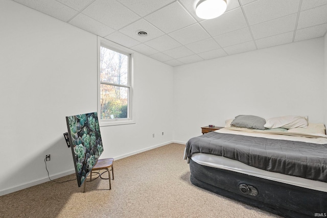 carpeted bedroom with a drop ceiling